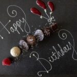 Elegant dark birthday celebration with moody atmospheric lighting