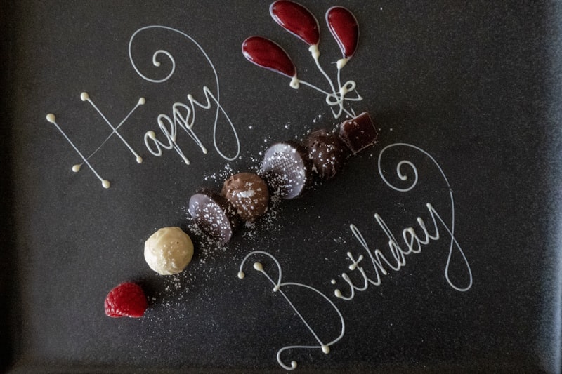 Elegant dark birthday celebration with moody atmospheric lighting