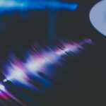 Vinyl record spinning in dark moody atmospheric music photography